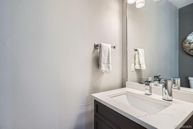 bathroom featuring toilet and vanity