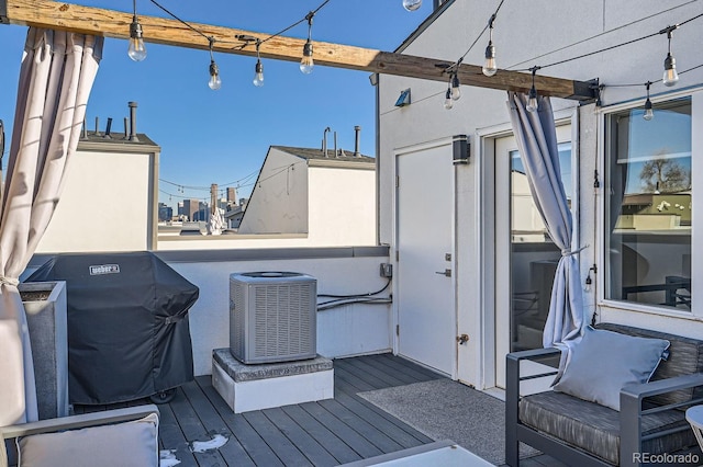 wooden terrace featuring central air condition unit and area for grilling