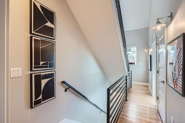 stairs with baseboards and wood finished floors