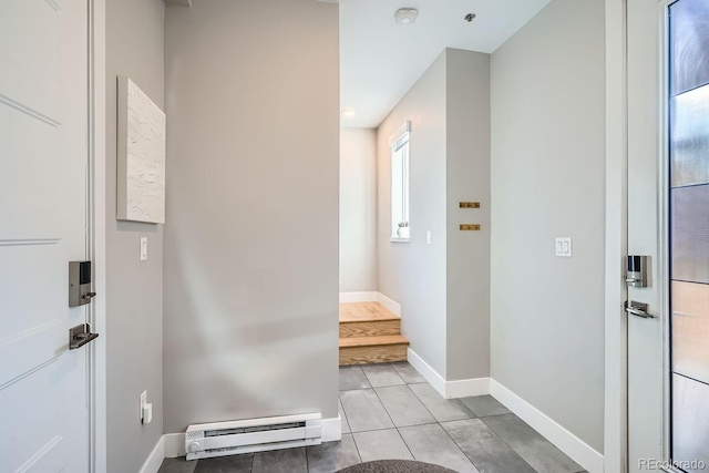 interior space with light tile patterned floors, baseboard heating, and baseboards