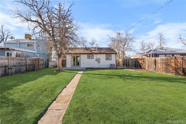 rear view of house with a yard