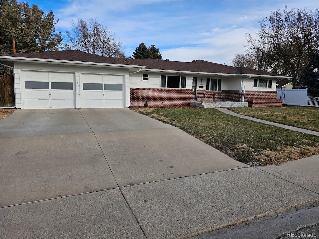 ranch-style house with a garage and a front lawn