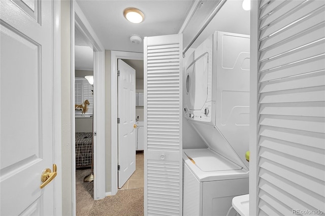 4259 S Richfield St, Aurora, CO 80013 - washroom with stacked washer / drying machine, light colored carpet, and light tile patterned floors