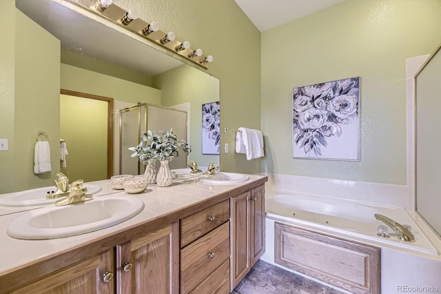 full bathroom featuring a jetted tub, a stall shower, double vanity, and a sink