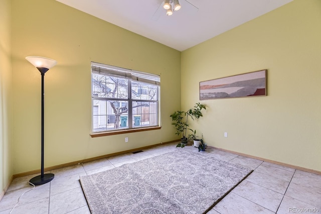 empty room with visible vents, baseboards, and tile patterned floors