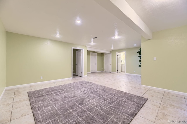 empty room featuring light tile patterned floors, recessed lighting, visible vents, and baseboards