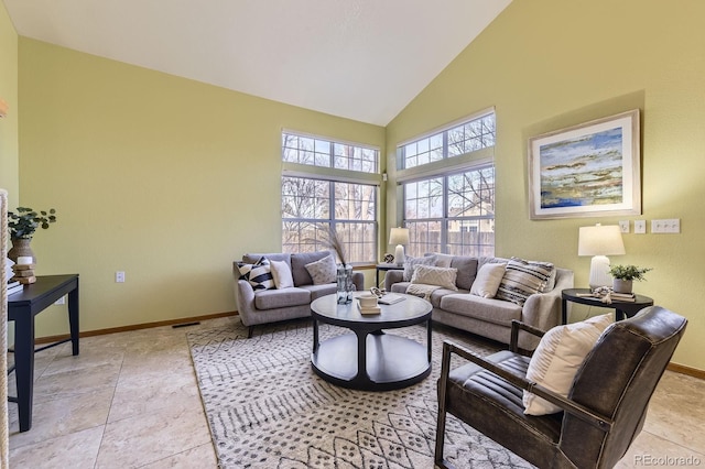 living area featuring light tile patterned floors, high vaulted ceiling, visible vents, and baseboards