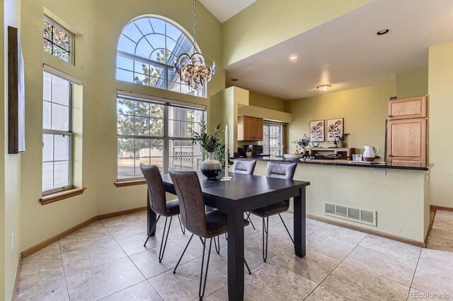 dining room featuring baseboards, visible vents, and a wealth of natural light