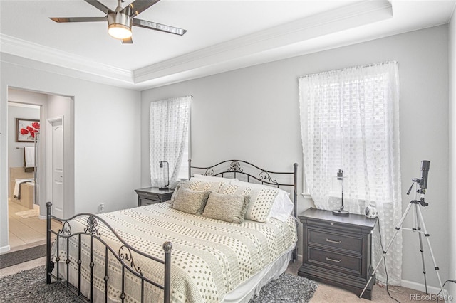 bedroom with a raised ceiling, ceiling fan, ornamental molding, and carpet floors