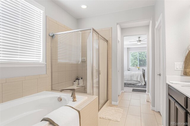 bathroom with tile patterned floors, independent shower and bath, ceiling fan, and vanity