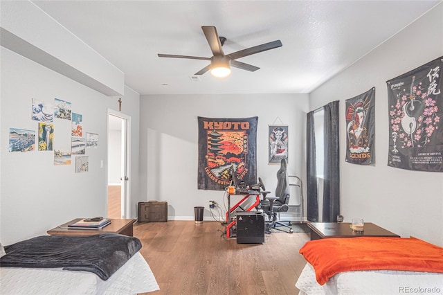 bedroom with ceiling fan and wood-type flooring