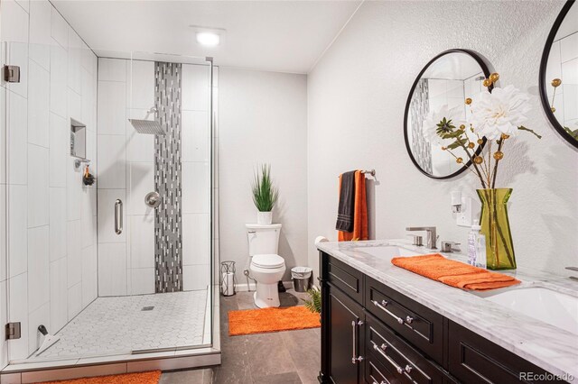 bathroom featuring vanity, toilet, and a shower with shower door