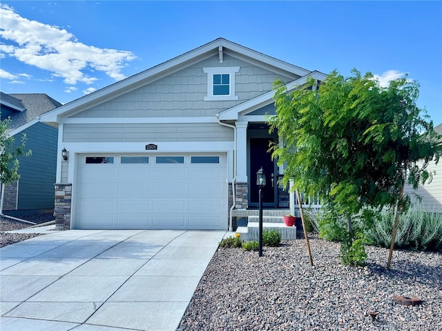 15979 Xanthia Way, Thornton, CO 80602 - view of front of house with stone siding, driveway, and an attached garage