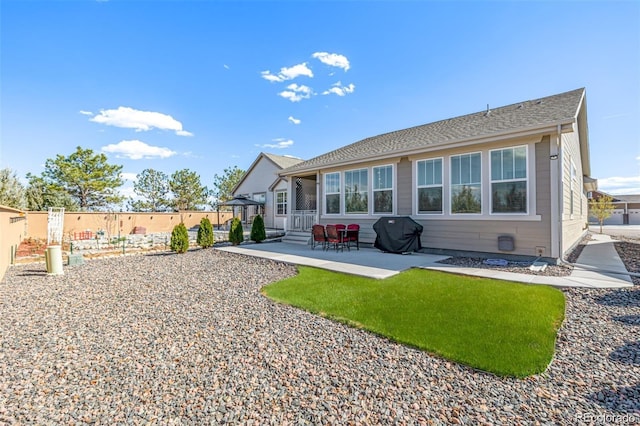 15979 Xanthia Way, Thornton, CO 80602 - rear view of property featuring a fenced backyard, a patio, and a shingled roof