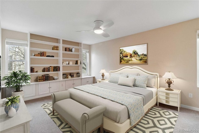 bedroom featuring light carpet, ceiling fan, and baseboards
