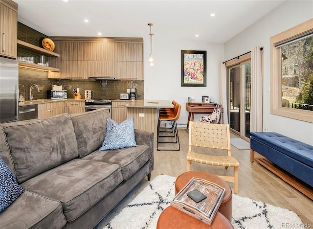 living room with recessed lighting and light wood-style flooring