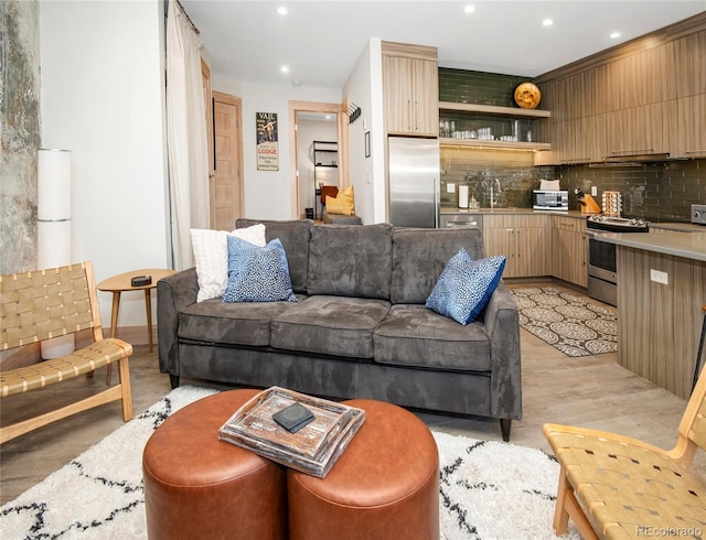 living room with recessed lighting and light wood-style floors