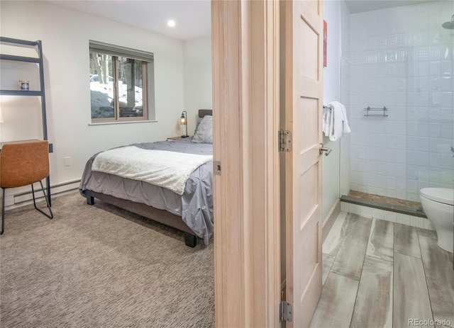 bedroom featuring recessed lighting, baseboards, and a baseboard heating unit