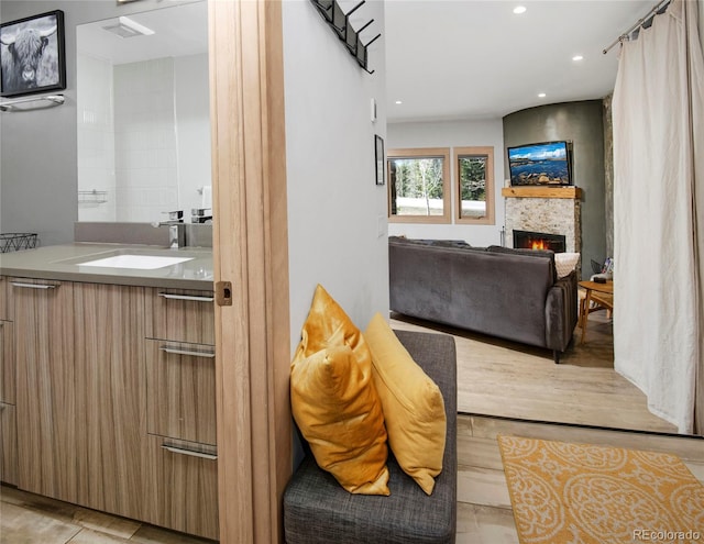 interior space featuring vanity, a fireplace, and recessed lighting