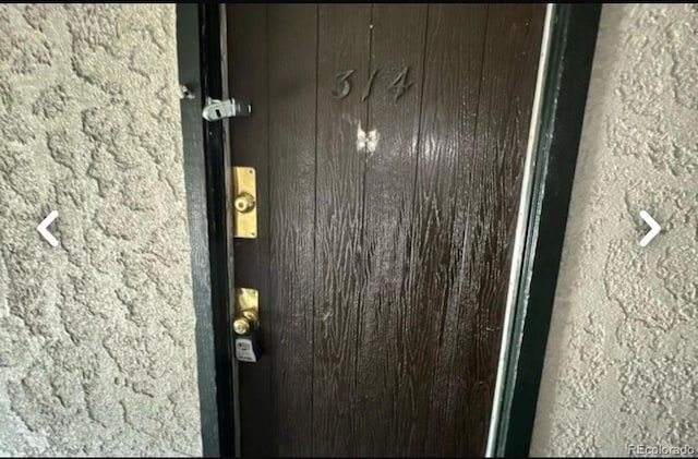 entrance to property featuring stucco siding