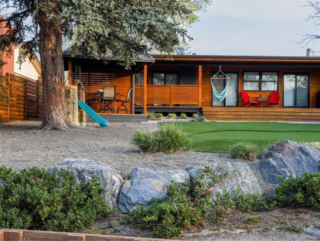 exterior space featuring a porch and fence