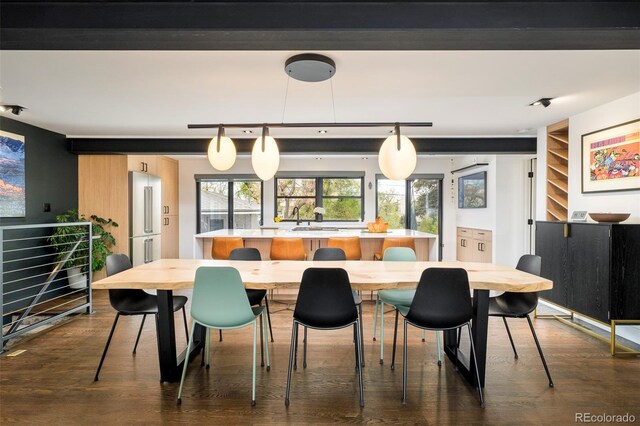 dining space with built in shelves and dark wood-type flooring