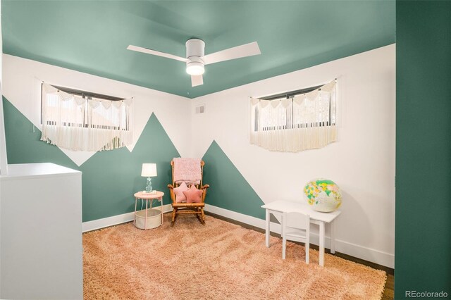 sitting room with baseboards, ceiling fan, visible vents, and a wealth of natural light