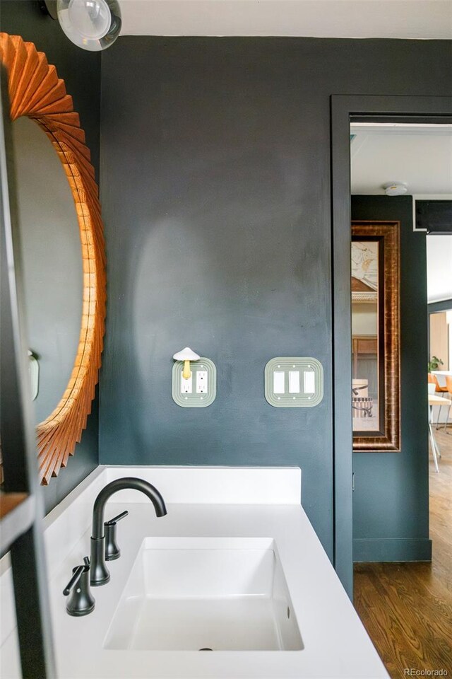 bathroom with a sink and wood finished floors