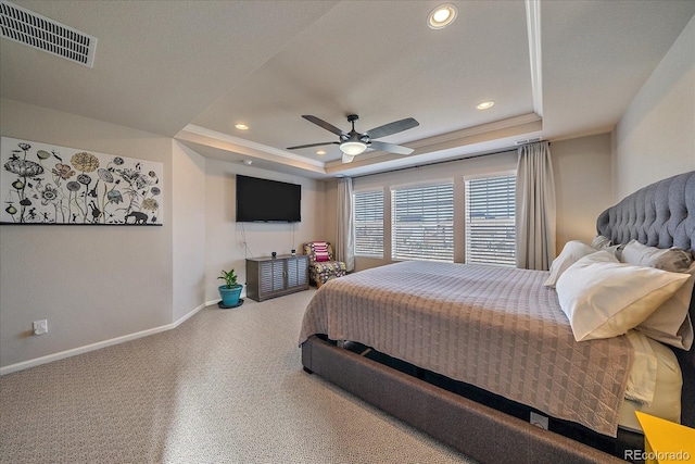 carpeted bedroom with a ceiling fan, baseboards, visible vents, a tray ceiling, and recessed lighting