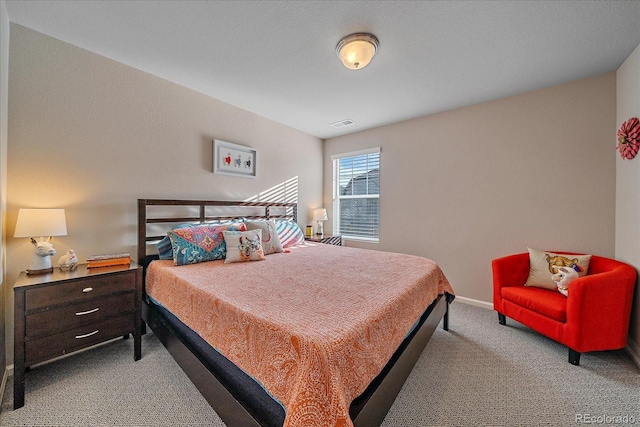 carpeted bedroom featuring baseboards and visible vents