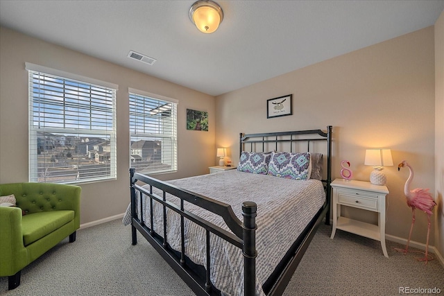 bedroom featuring visible vents, baseboards, and carpet