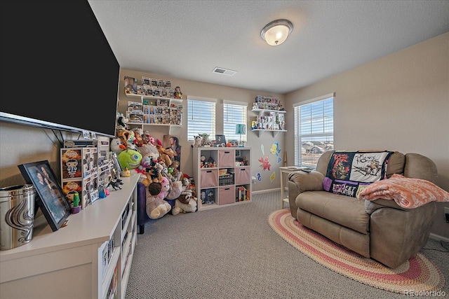 interior space with visible vents, carpet, baseboards, and a textured ceiling