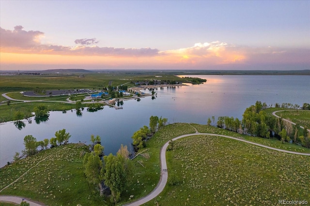 aerial view at dusk with a water view