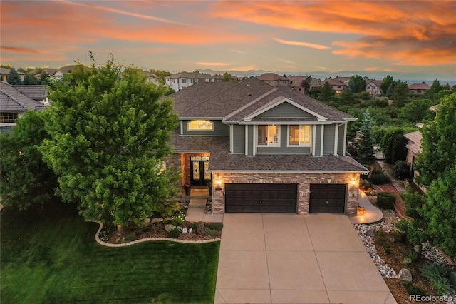 view of front of home with a garage and a yard