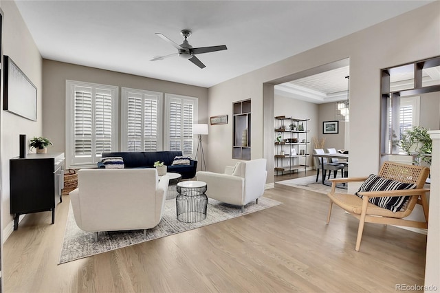 living room featuring a wealth of natural light, light hardwood / wood-style flooring, and ceiling fan