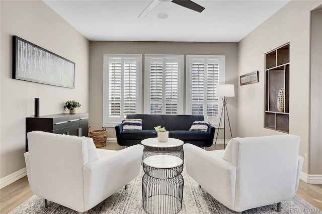 living room featuring ceiling fan and light wood-type flooring