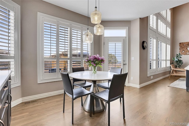 dining area with light hardwood / wood-style floors