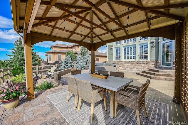 view of patio featuring a hot tub and a gazebo