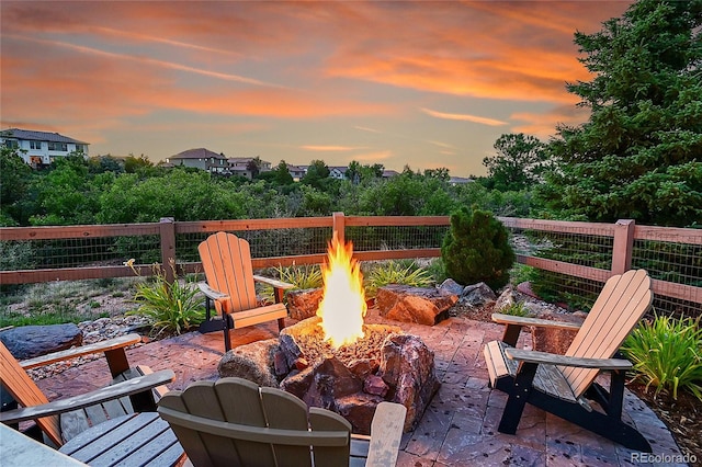 patio terrace at dusk featuring a fire pit