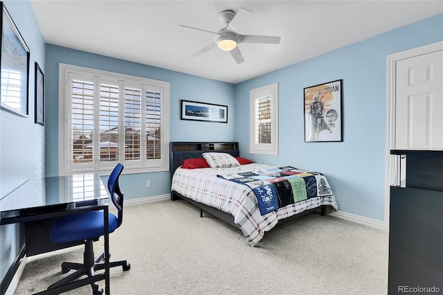 carpeted bedroom featuring multiple windows and ceiling fan