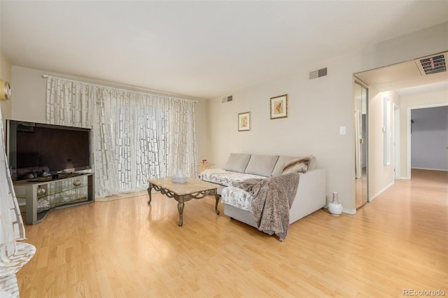 living room with light hardwood / wood-style flooring