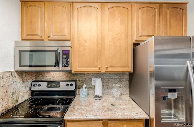 kitchen featuring decorative backsplash, light brown cabinets, stainless steel appliances, and light stone countertops