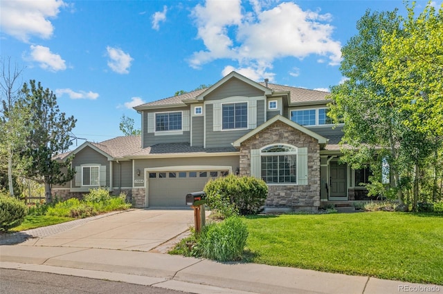 craftsman-style house featuring stone siding, an attached garage, driveway, a front yard, and roof with shingles