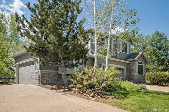 view of front facade featuring stone siding, concrete driveway, and an attached garage