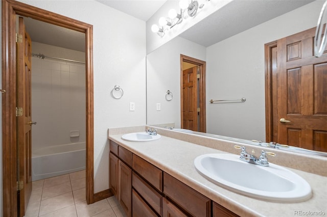 full bath with tile patterned floors, double vanity, and baseboards