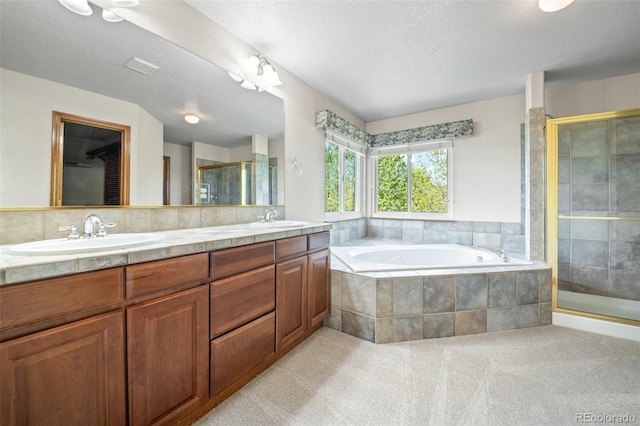 full bathroom with a stall shower, a garden tub, and double vanity