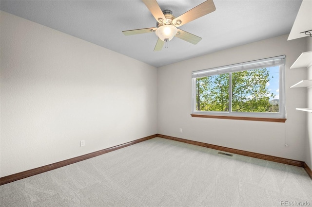 empty room featuring light carpet, baseboards, and ceiling fan