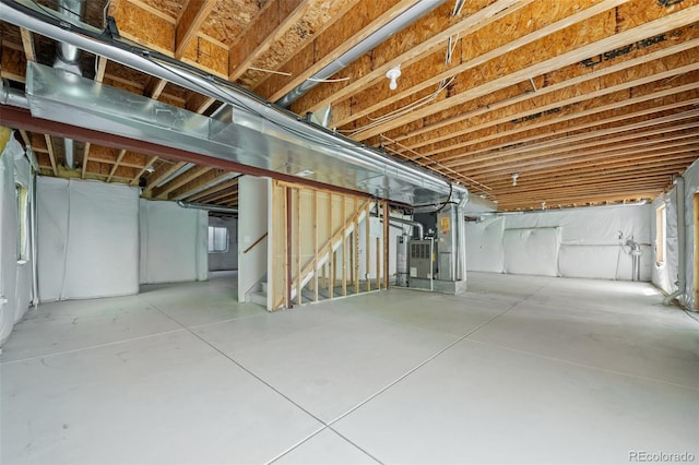 unfinished below grade area with stairs and heating unit