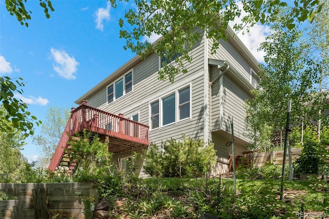view of home's exterior with a wooden deck