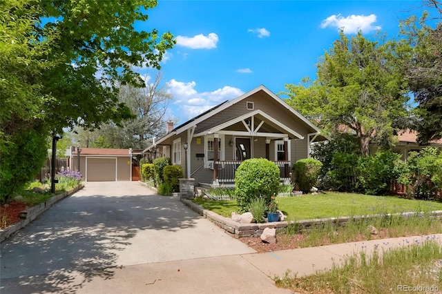 4779 S Bannock St, Englewood, CO 80110 - view of front of house featuring a porch, driveway, a front lawn, and a chimney